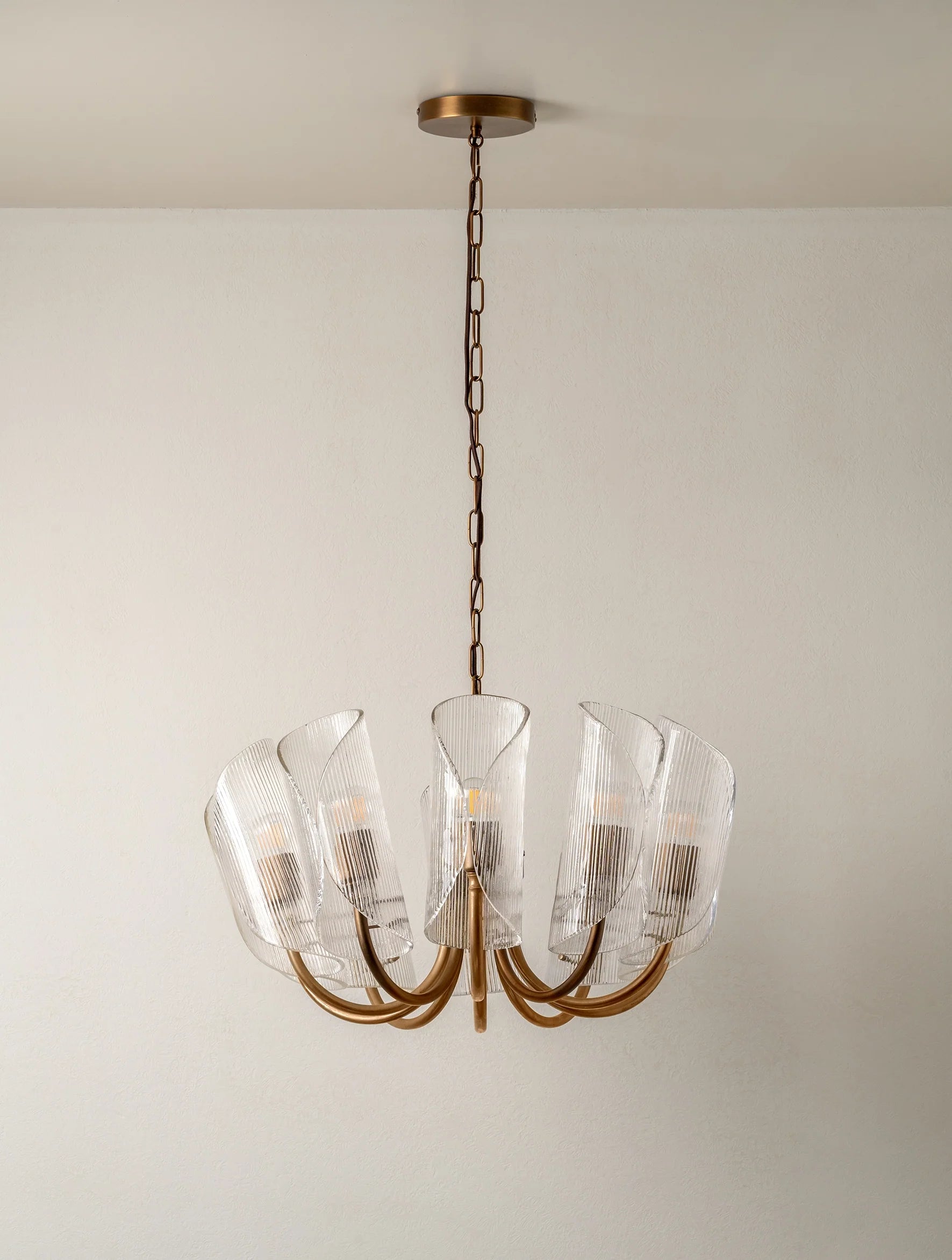 Cannoli - 10 light aged brass and textured glass chandelier