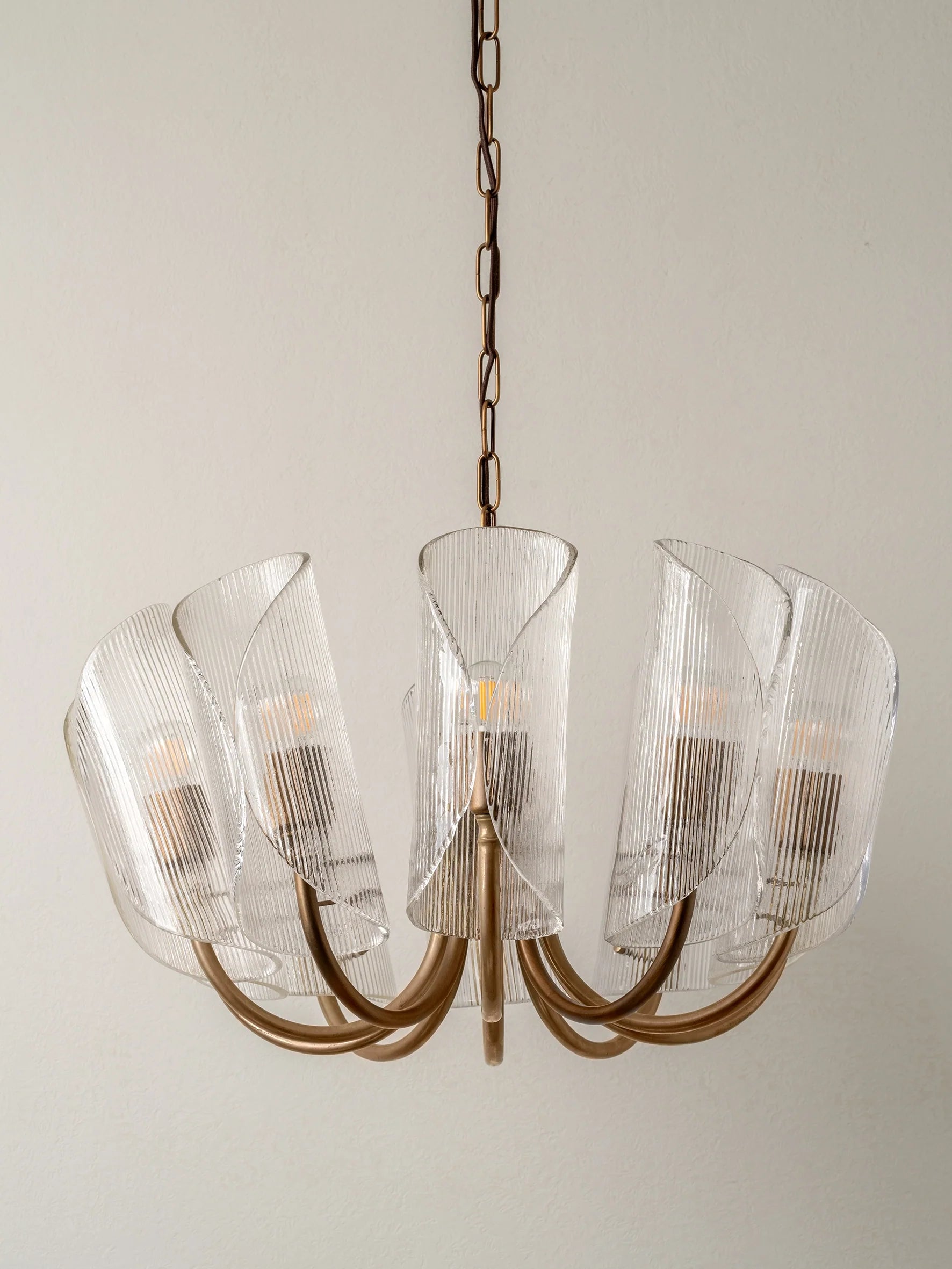 Cannoli - 10 light aged brass and textured glass chandelier