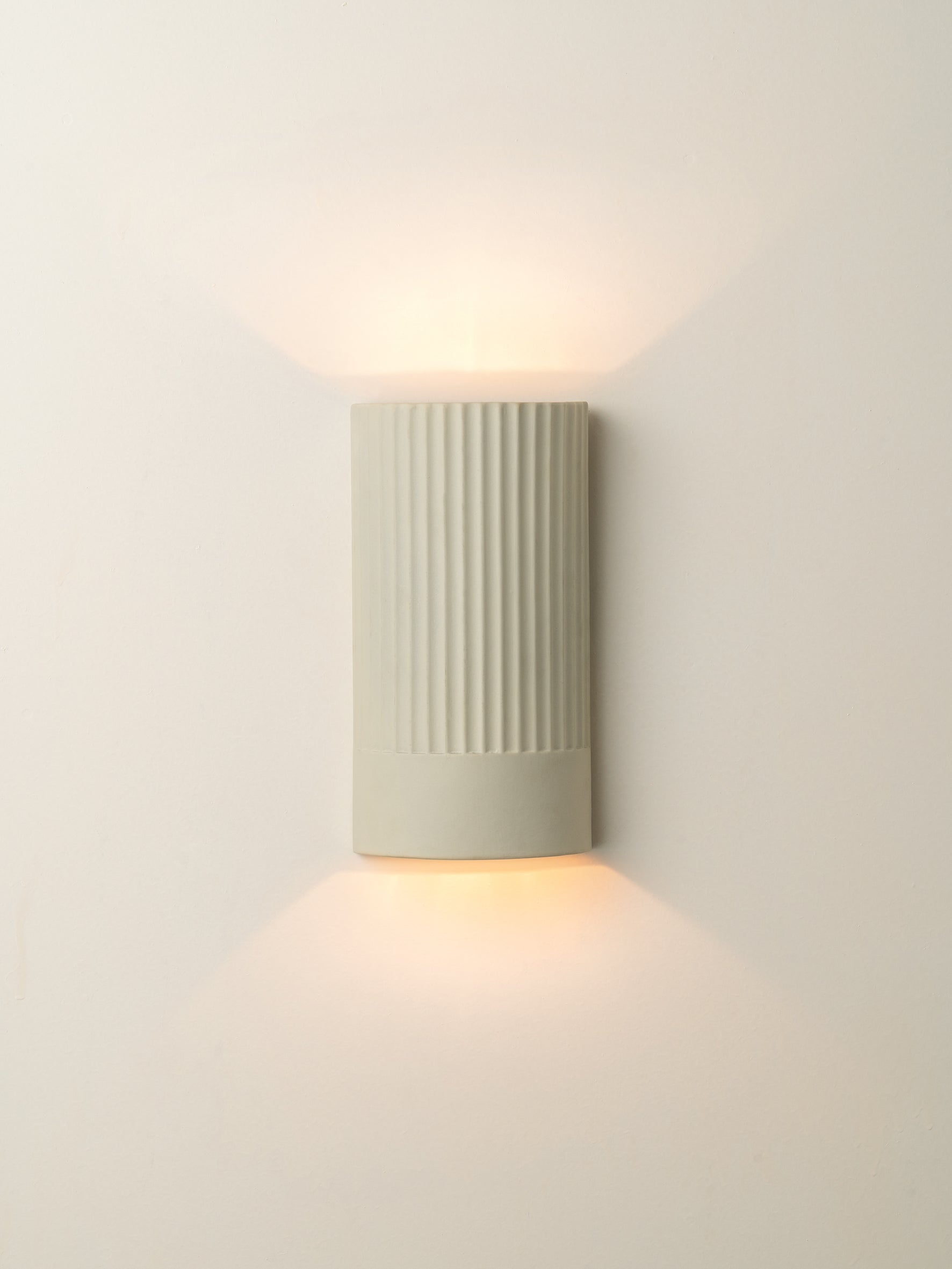 Enza - warm white  ribbed ceramic wall light