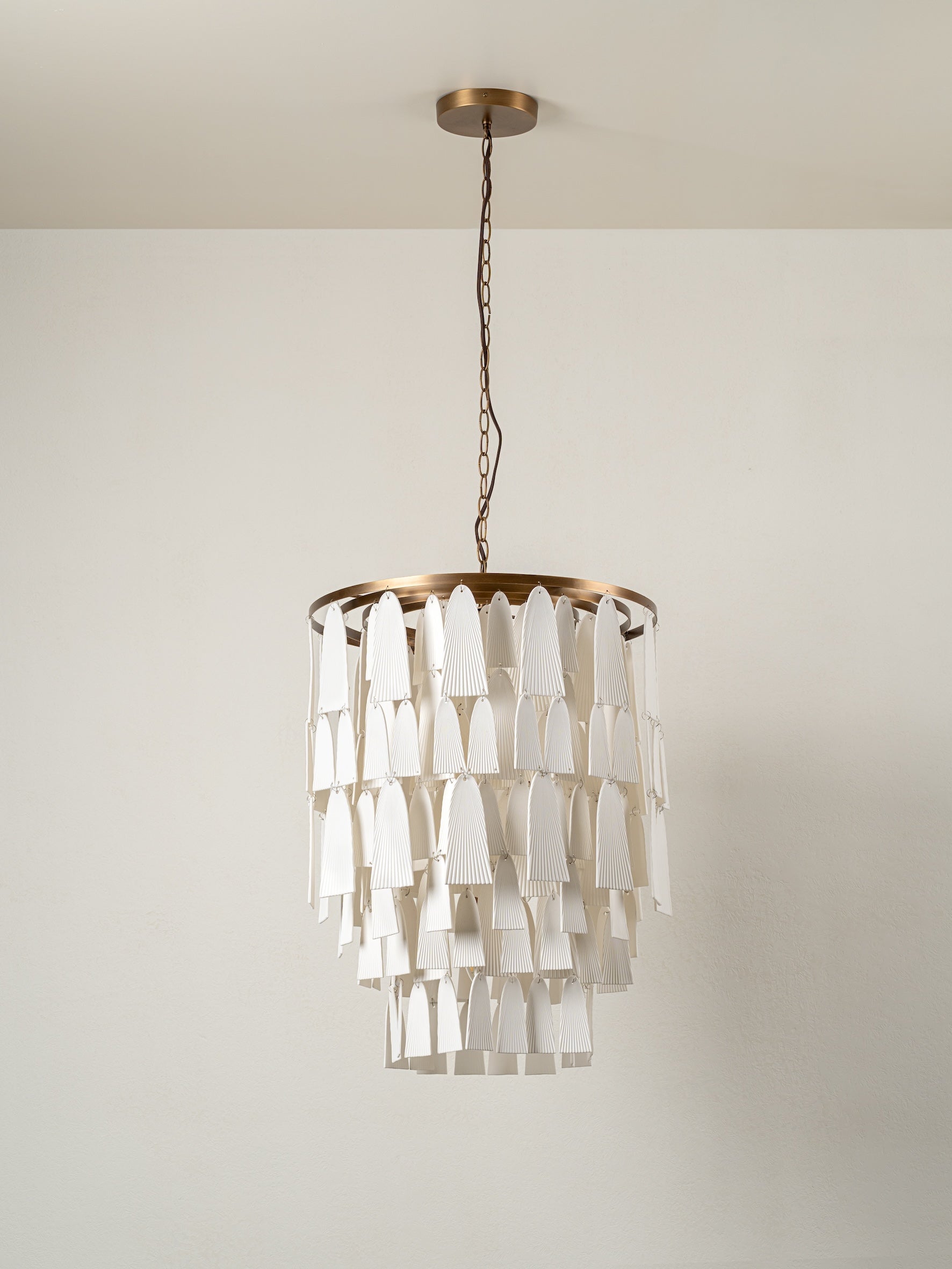 Kaolin - 4 light tiered aged brass and porcelain chandelier