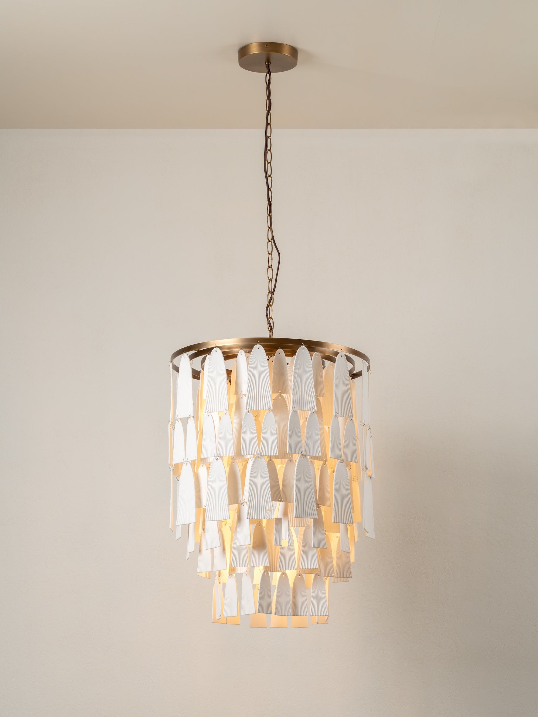 Kaolin - 4 light tiered aged brass and porcelain chandelier