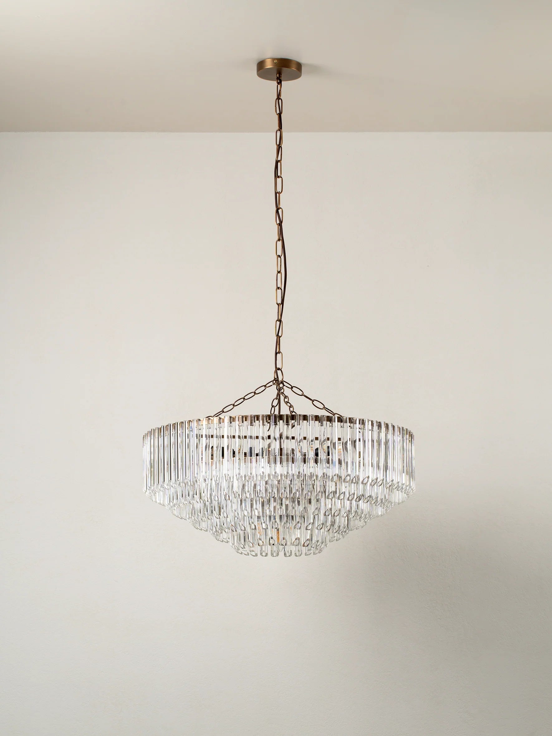 Petalia - 9 light aged brass and clear glass tube wide chandelier