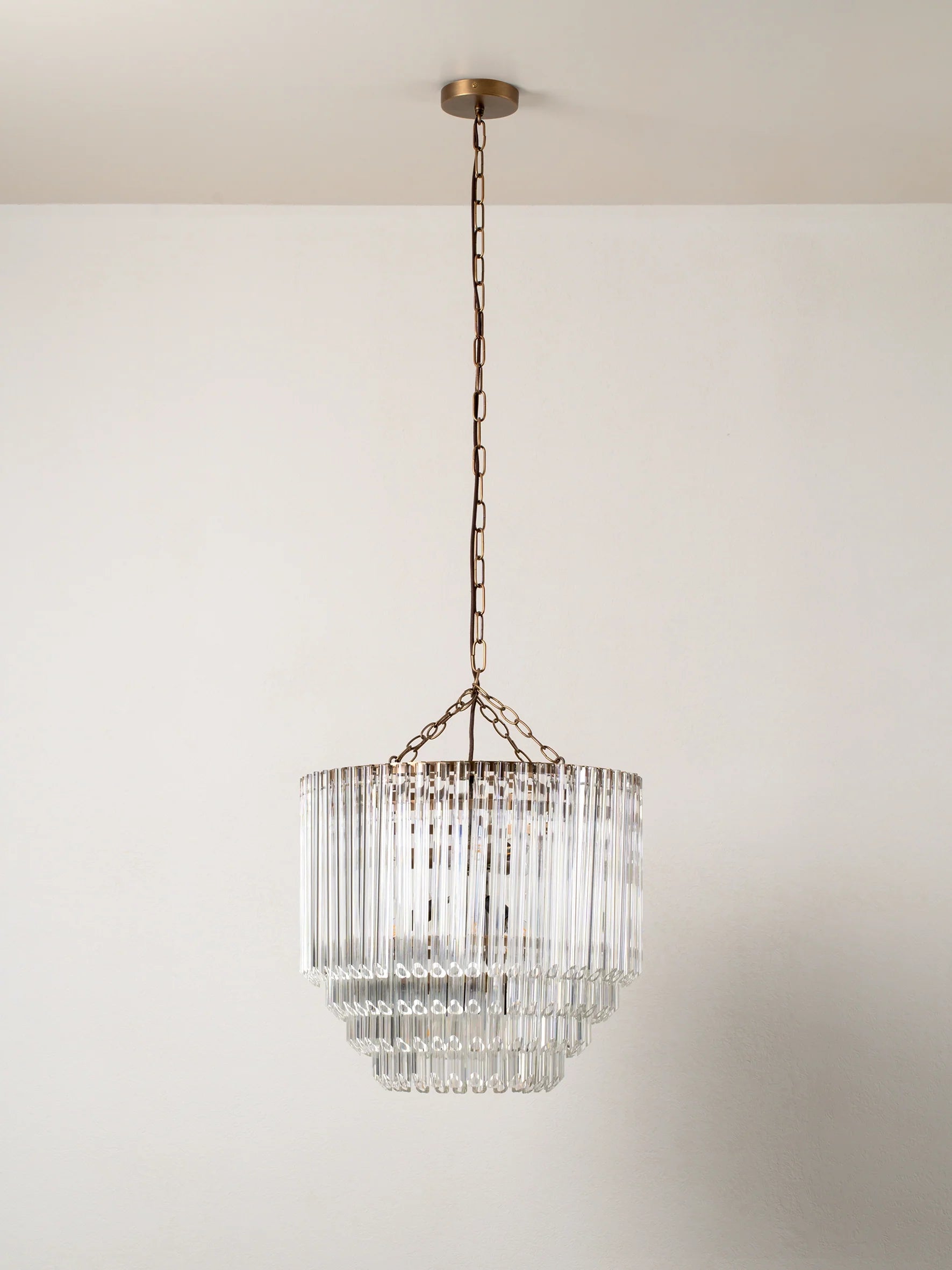 Petalia - 9 light aged brass and clear glass tube tall chandelier