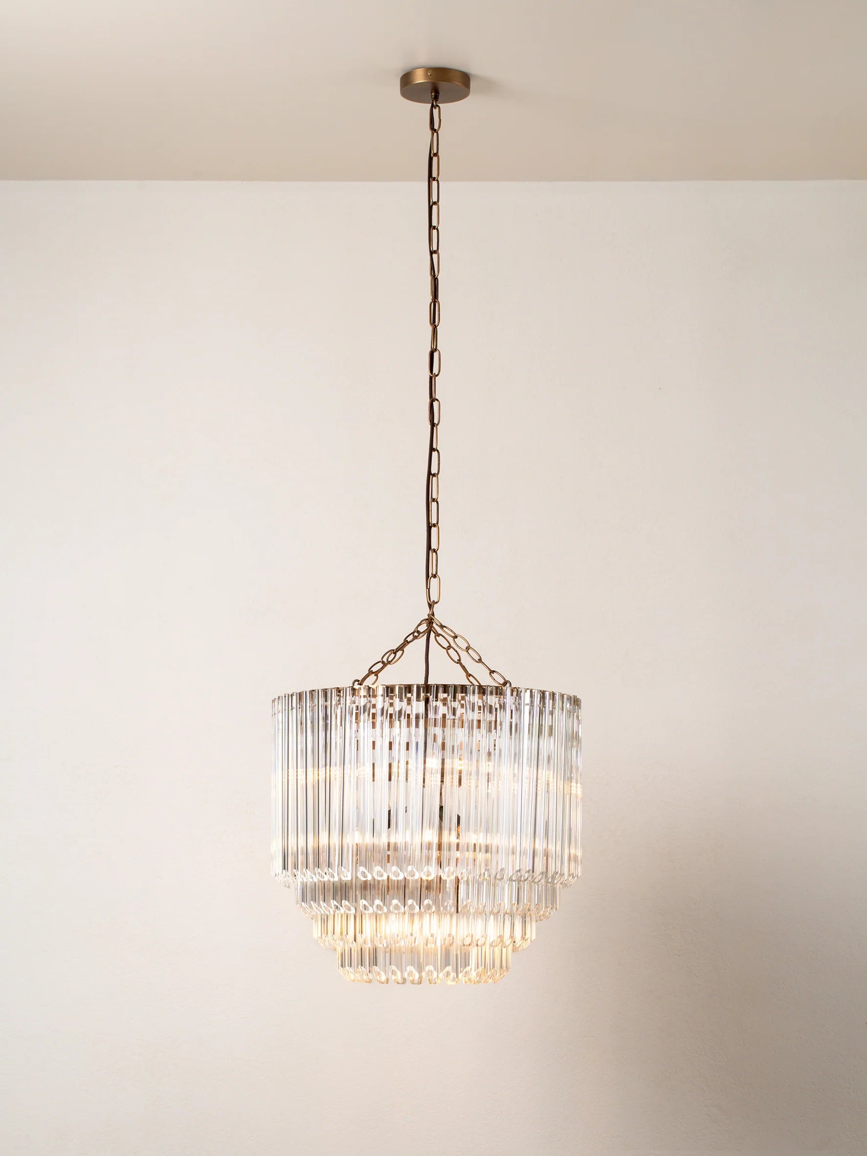 Petalia - 9 light aged brass and clear glass tube tall chandelier